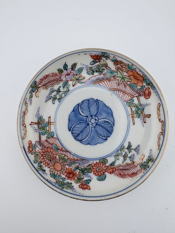 Meiji Imari iroe plate with stylised blossom motif, blue central medallion, and red‑green floral panels – Kotto Living