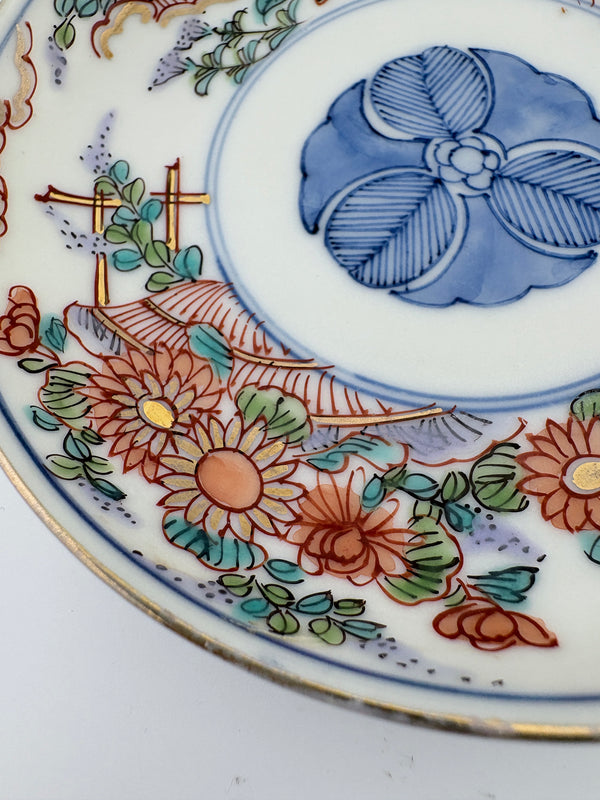 Meiji Imari iroe plate with stylised blossom motif, blue central medallion, and red‑green floral panels – Kotto Living